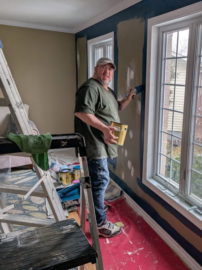 Owner and operator of painting By Ryan painting around Windows.